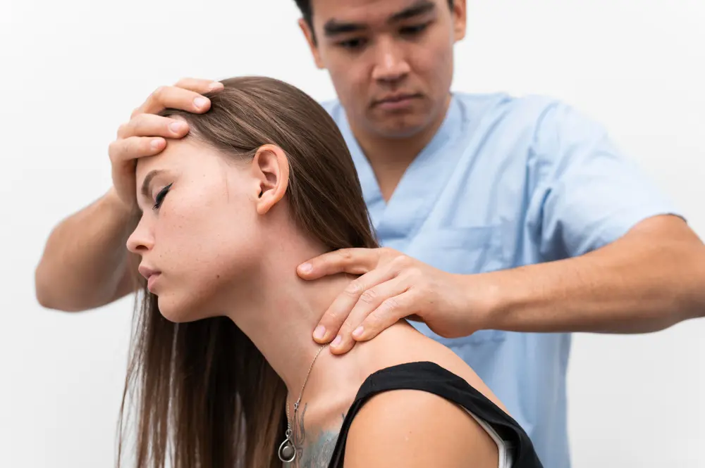 Doctor examining patient's neck for whiplash injury.
