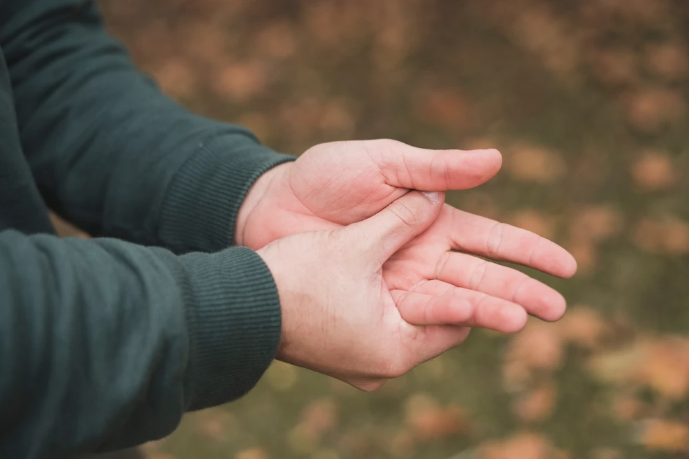 Person experiencing tingling in hands and feet due to nerve irritation