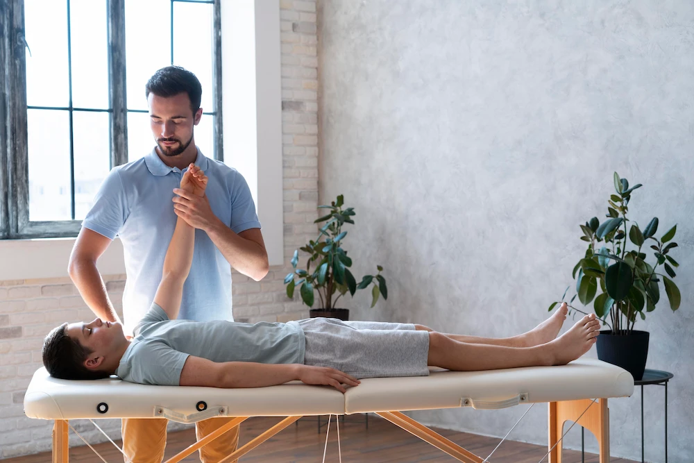 Chiropractor examining patient posture and spine during initial consultation