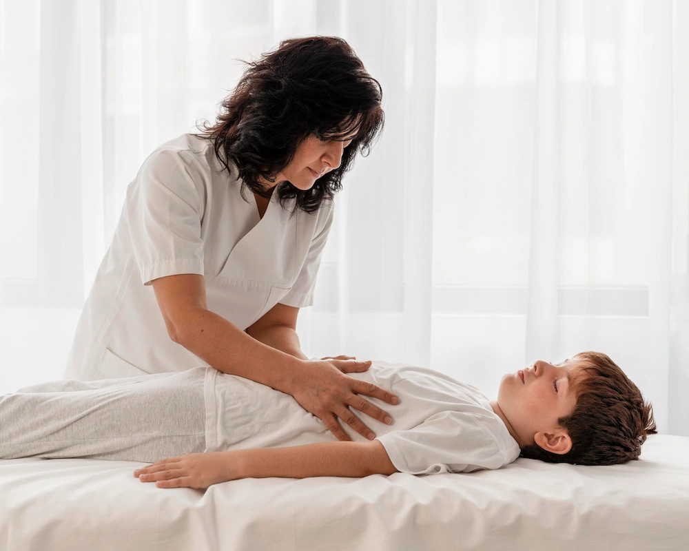 Pediatric chiropractor providing gentle chiropractic care to a child in a clinic